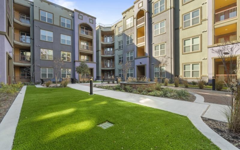 a lawn in front of a building complex