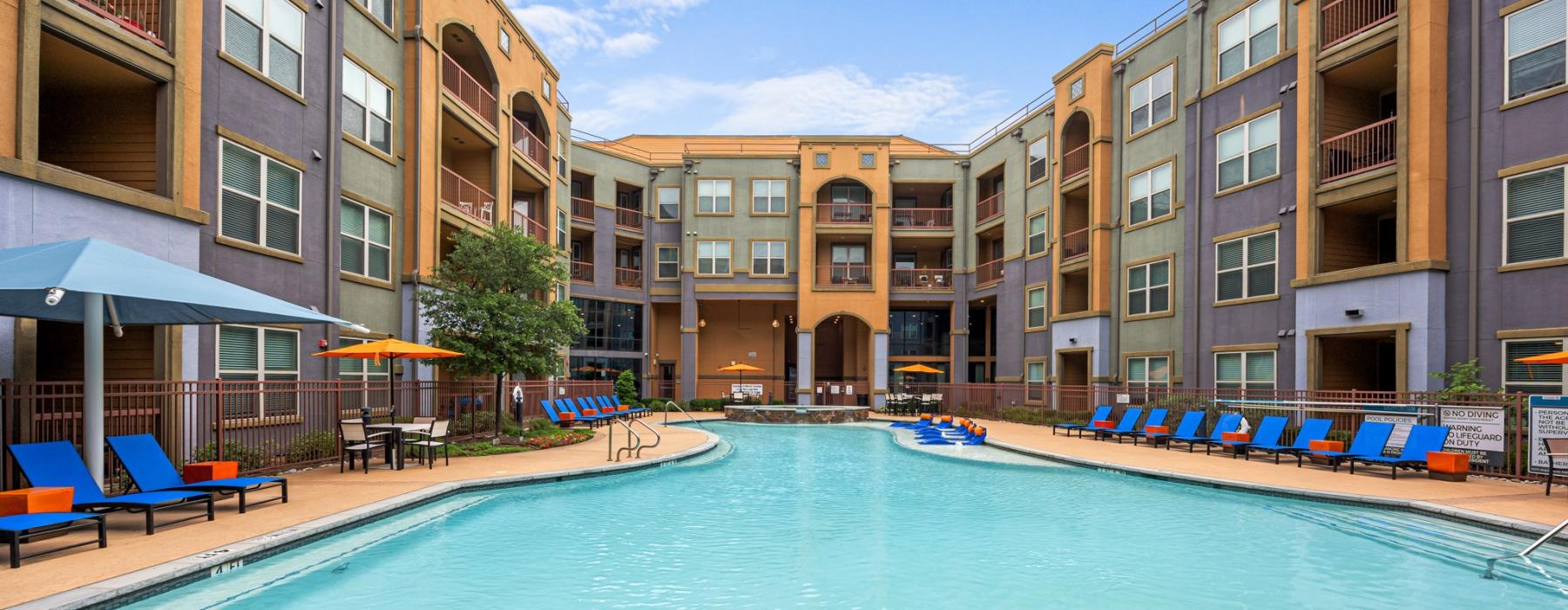 a pool with a building surrounding it