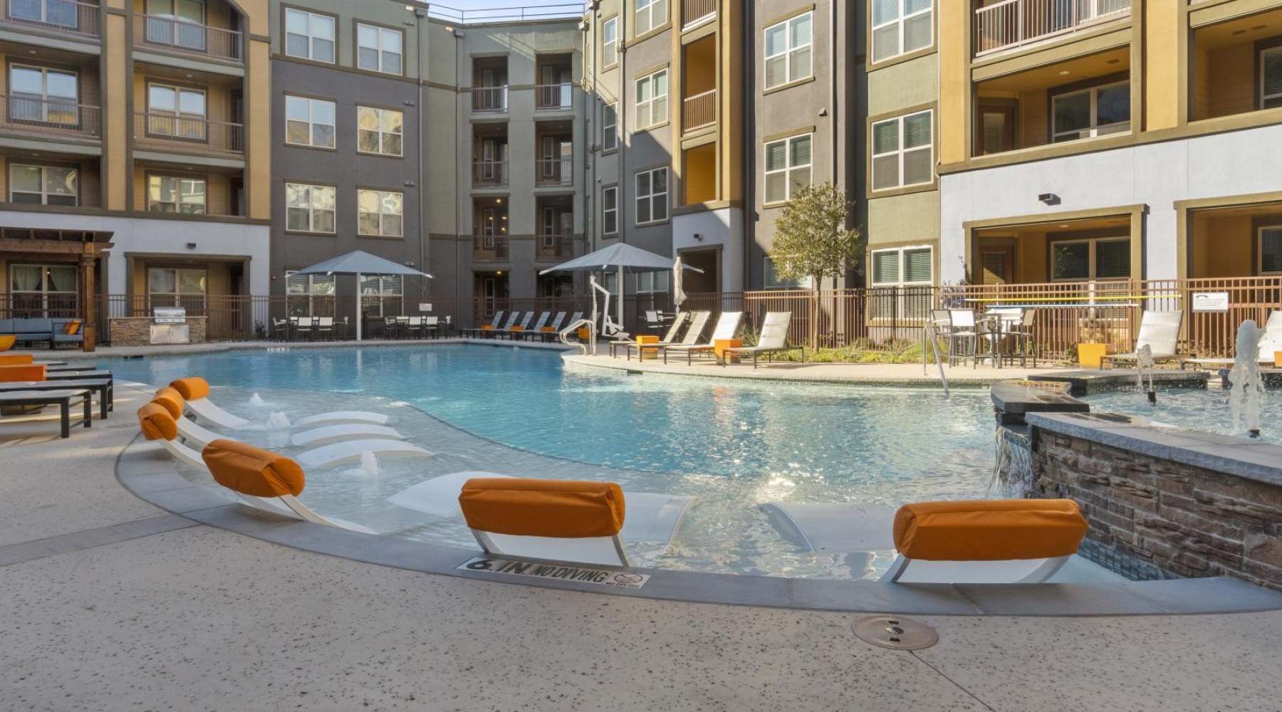 a pool in a courtyard with buildings around it