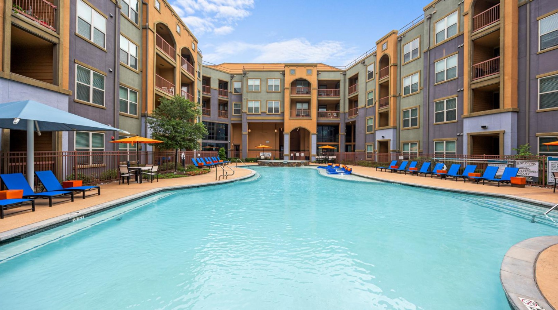 a pool with a building surrounding it