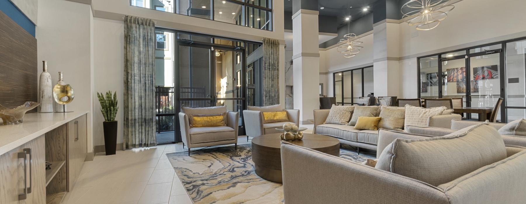 a large lounge room with a large glass wall and a large white couch