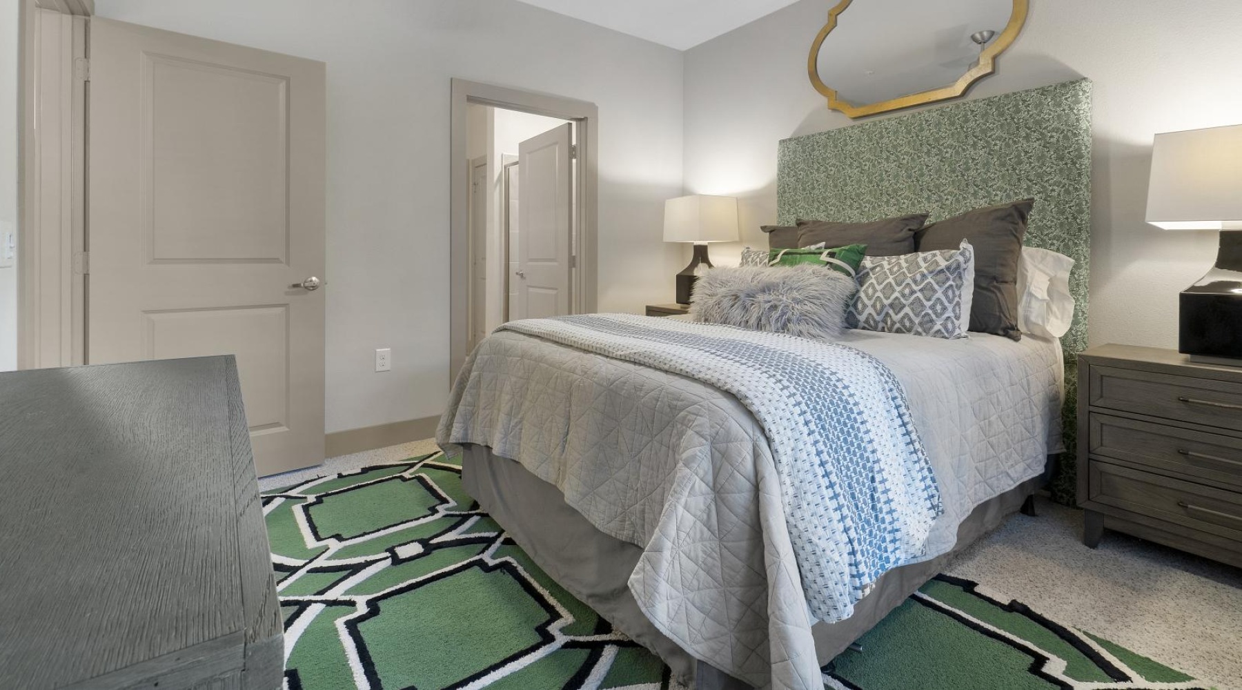 a bedroom with a bed and a fan